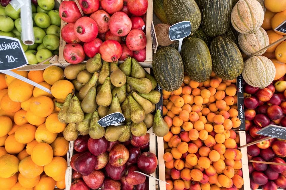 Produce laid out at a busy market